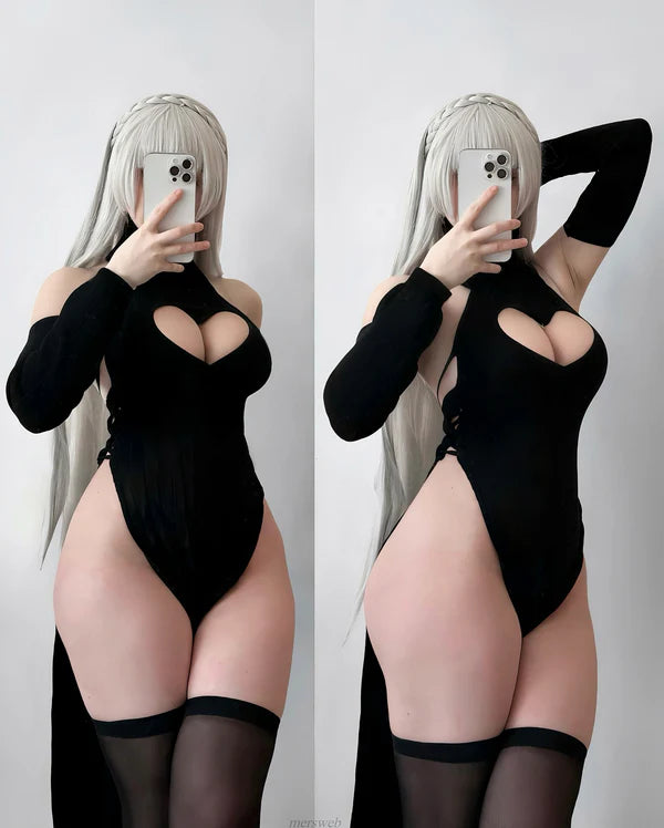 Person wearing a black bodysuit with cut-out design against a white background