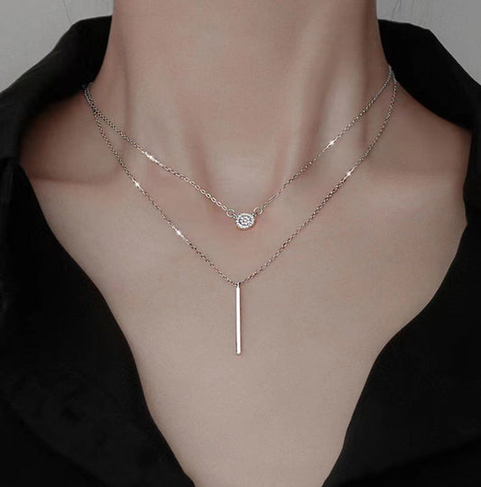 Two necklaces on a mannequin with a plain background S925 Sterling Silver Double Layer Necklace – Zircon Pave Long Stick Pendant Layered Necklaces mpncm1-10.myshopify.com s925-double-layer-zircon-stick-pendant-necklace Fittyluxe