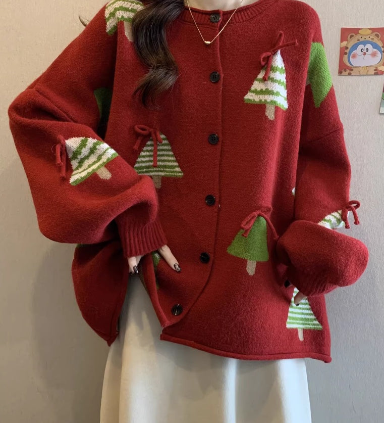 Red cardigan with green tree patterns worn by a person against a plain background Festive Red Christmas Tree Knit Cardigan – Oversized Holiday Sweater Coat sweater & coat mpncm1-10.myshopify.com womens-oversized-red-christmas-tree-cardigan-sweater Fittyluxe